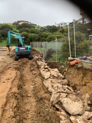 Professional rock breaking excavation work in residential area, Mandurah - specialized equipment for hard ground conditions